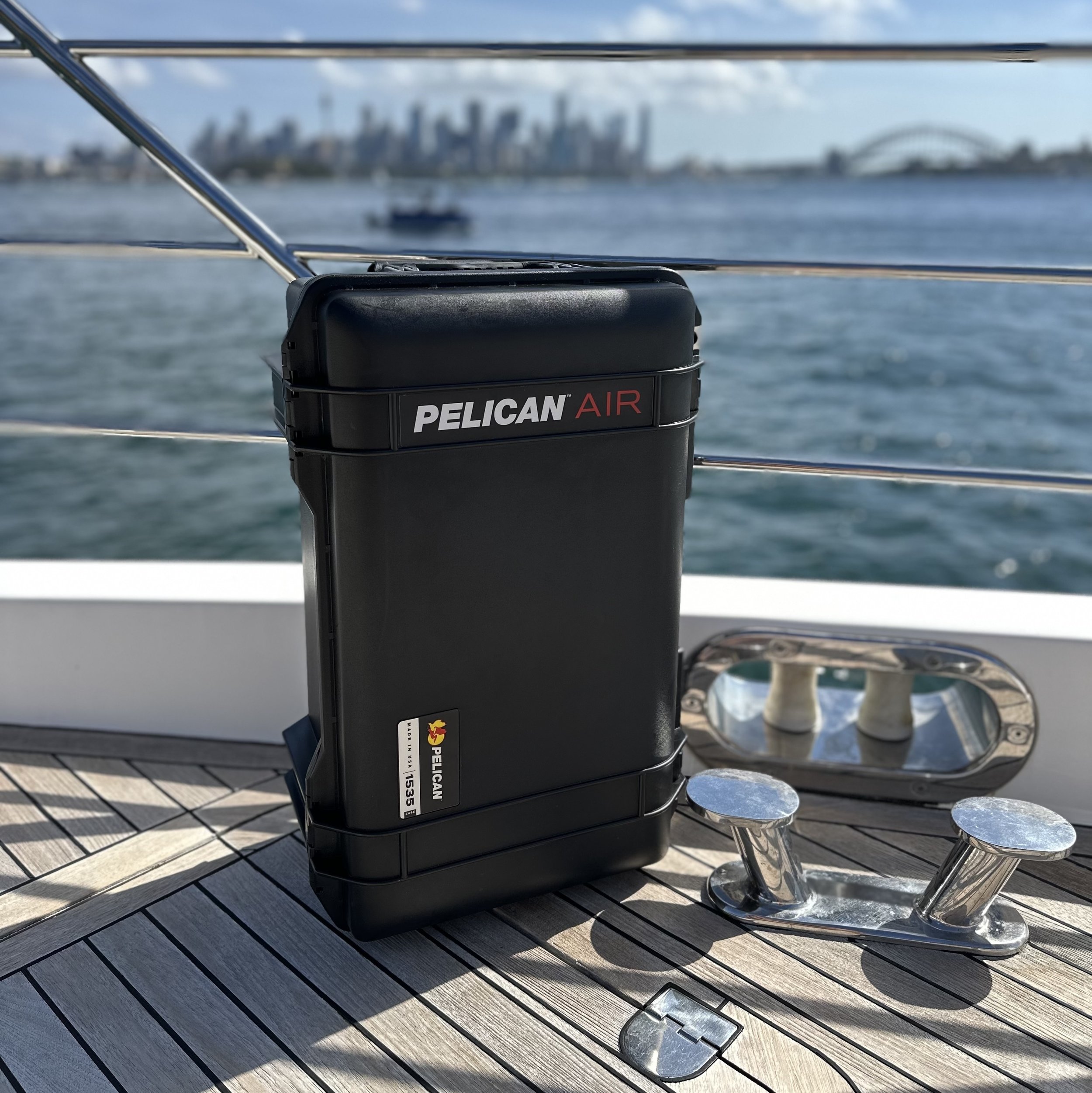 Case on a boat deck with a city skyline