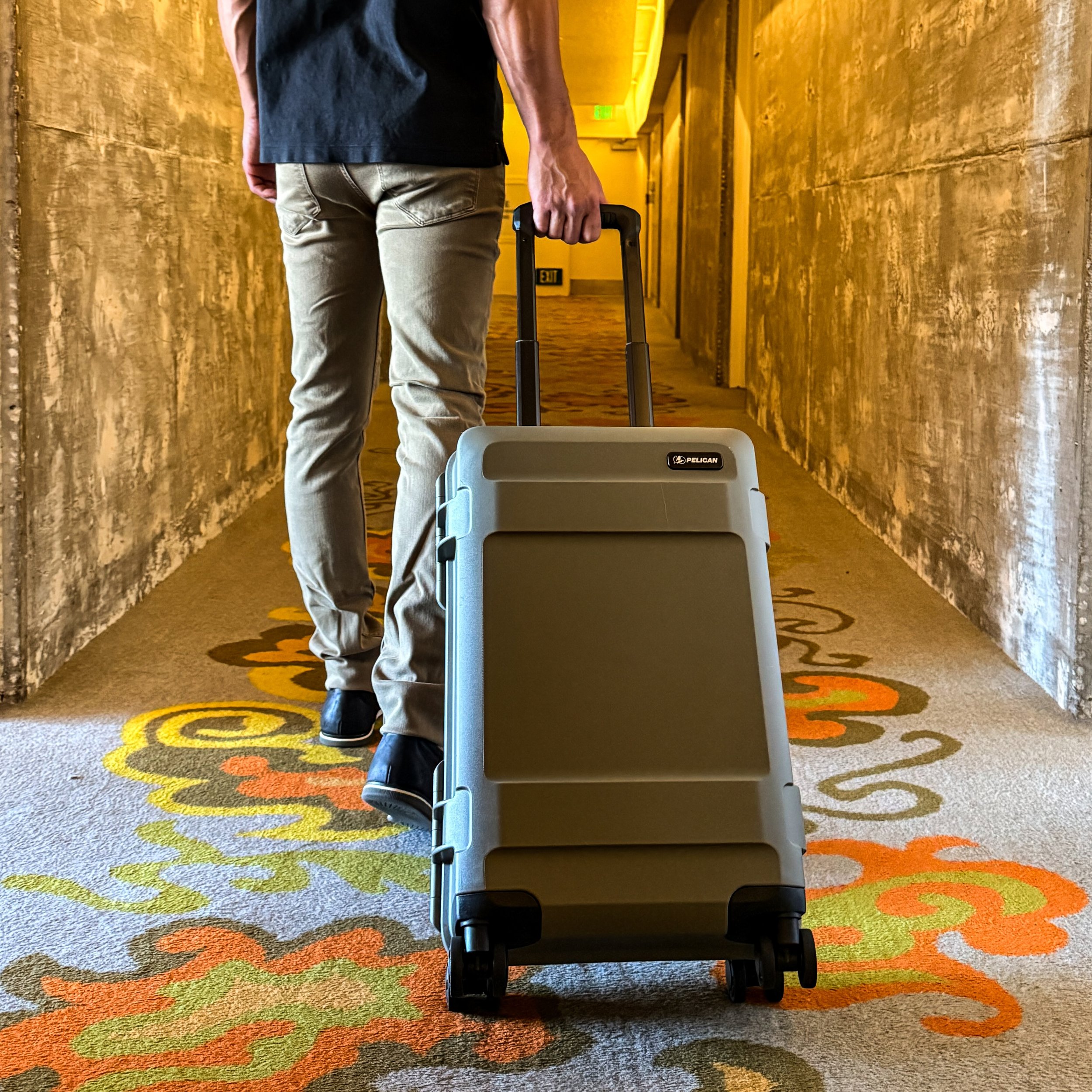 Business traveler with rolling case in a hotel hallway